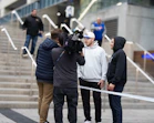 Filming a group of people on outdoor stairs