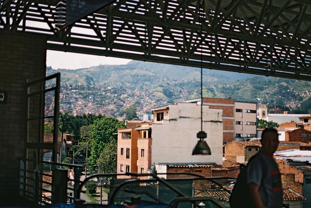 View over Medellín's hillside neighborhoods with the metro bridge in the foreground