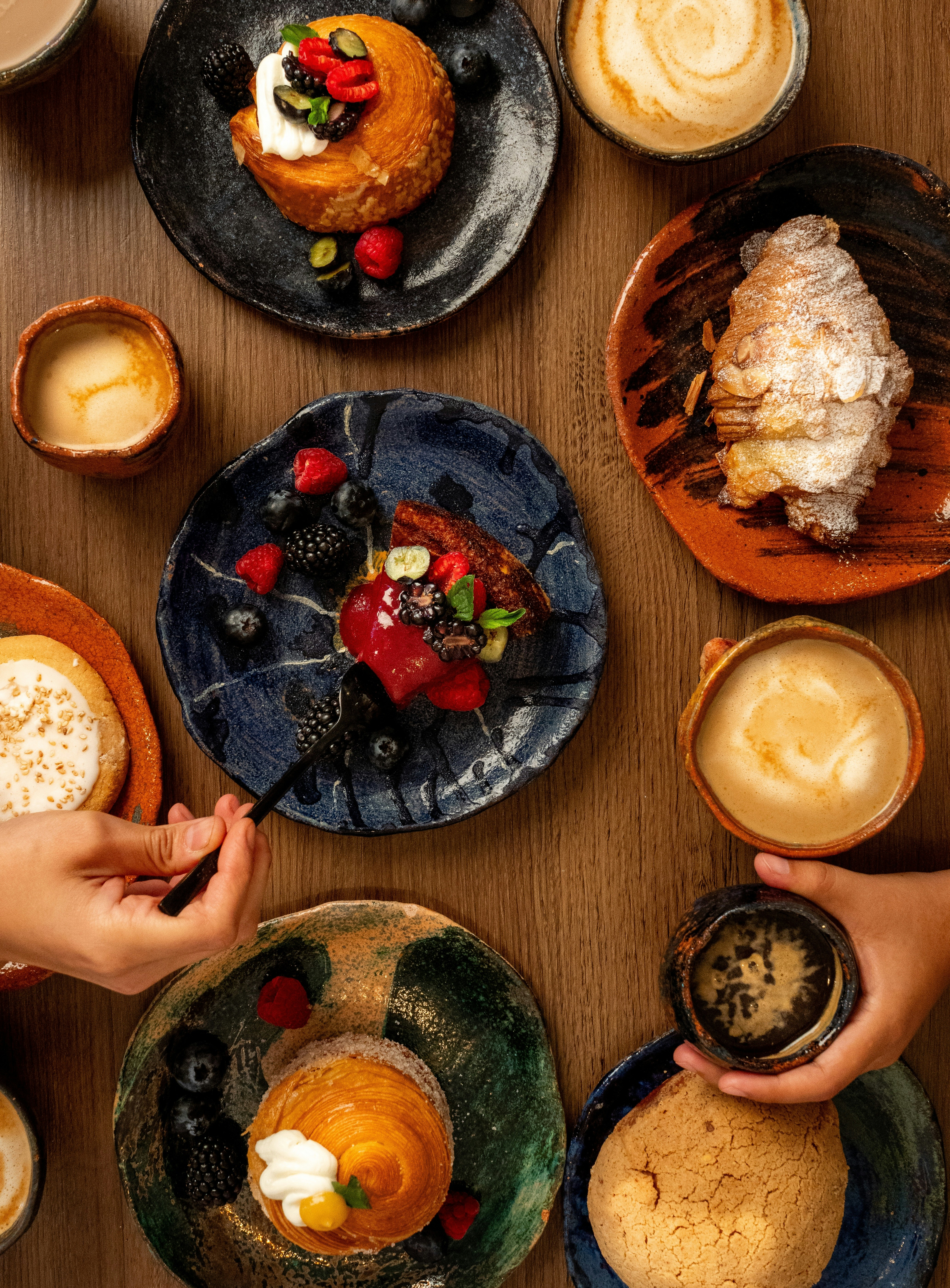 Assortment of pastries and coffee on a wooden table