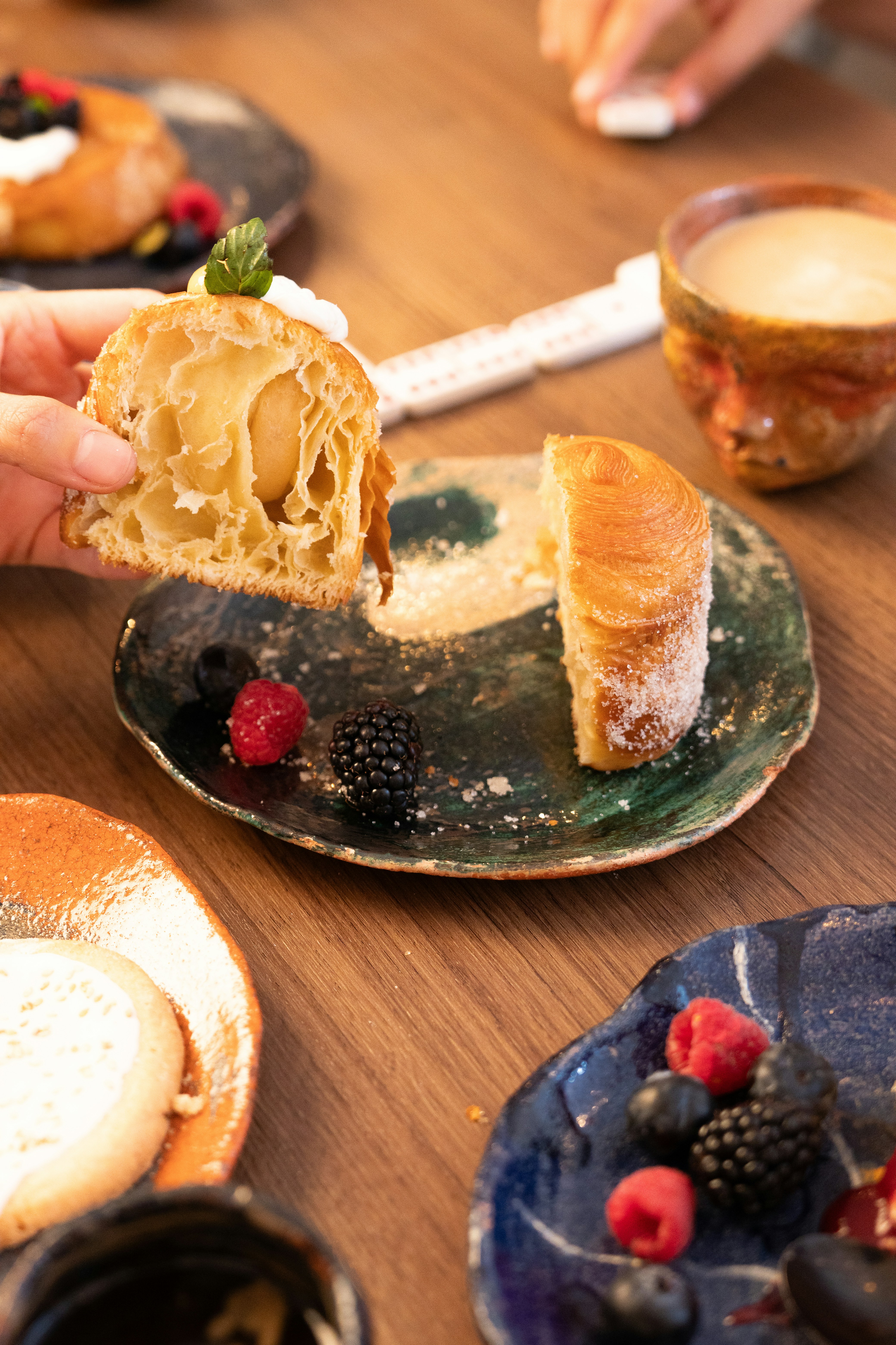 Croissant pastry with berries and coffee on a table