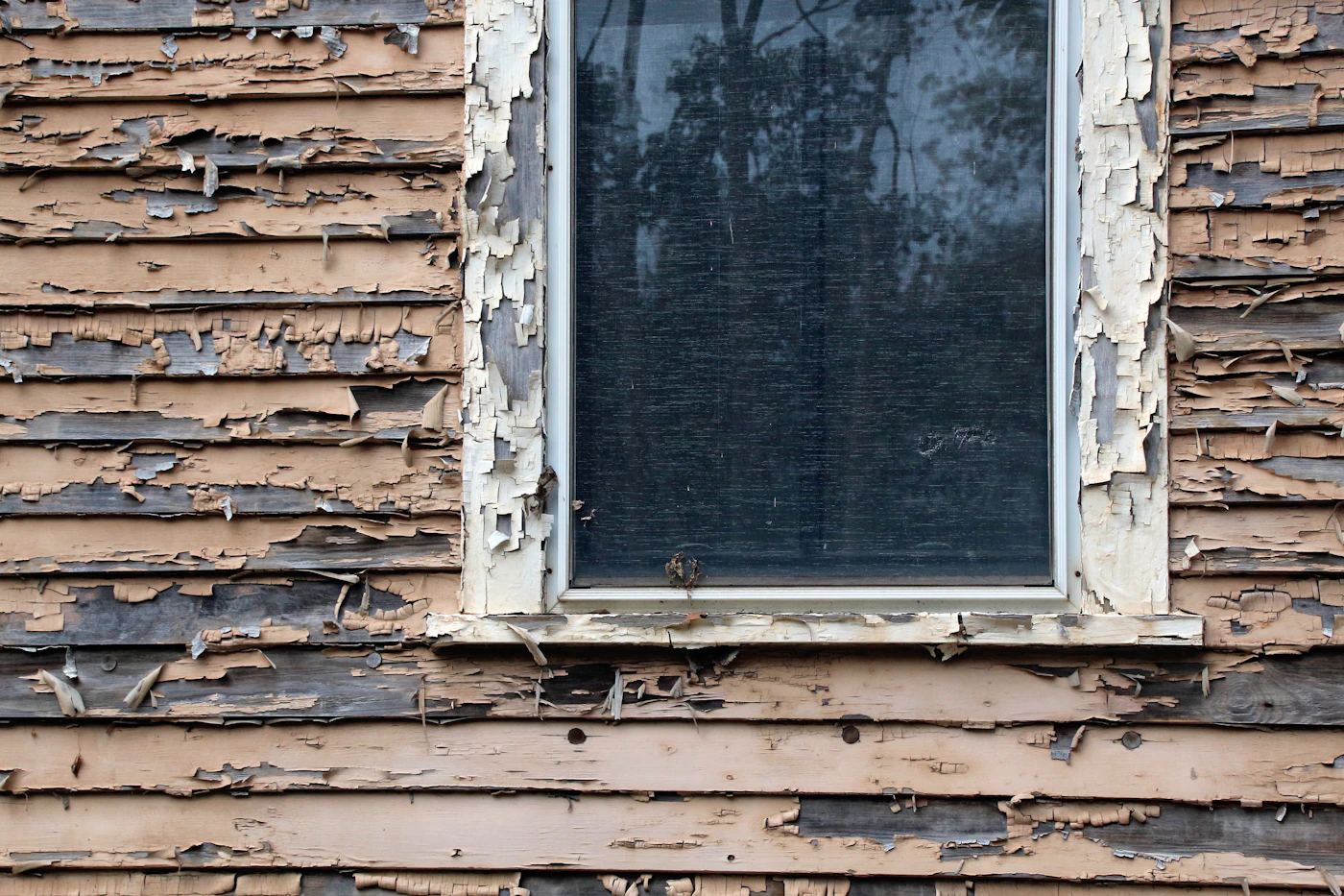 Storm-damaged residential exterior after severe weather