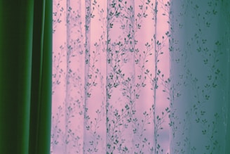 Sheer floral curtains with green drapes