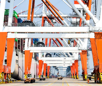 Industrial cranes at a busy shipping port.