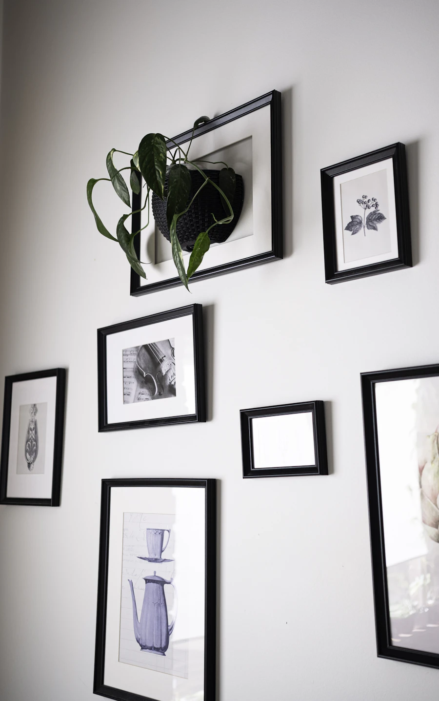 Framed artwork arranged on an interior wall