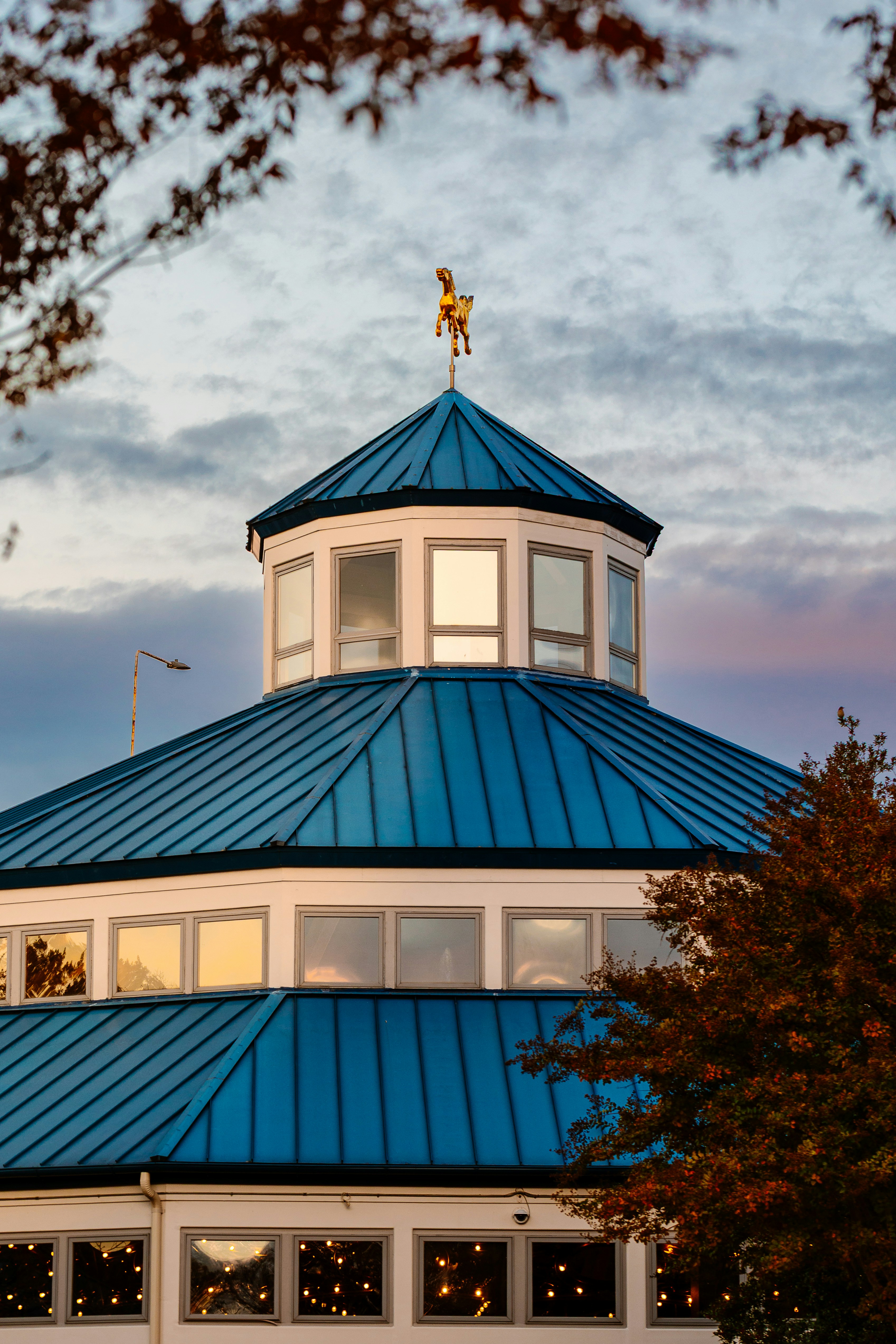 Carousel building with golden goat weather vane