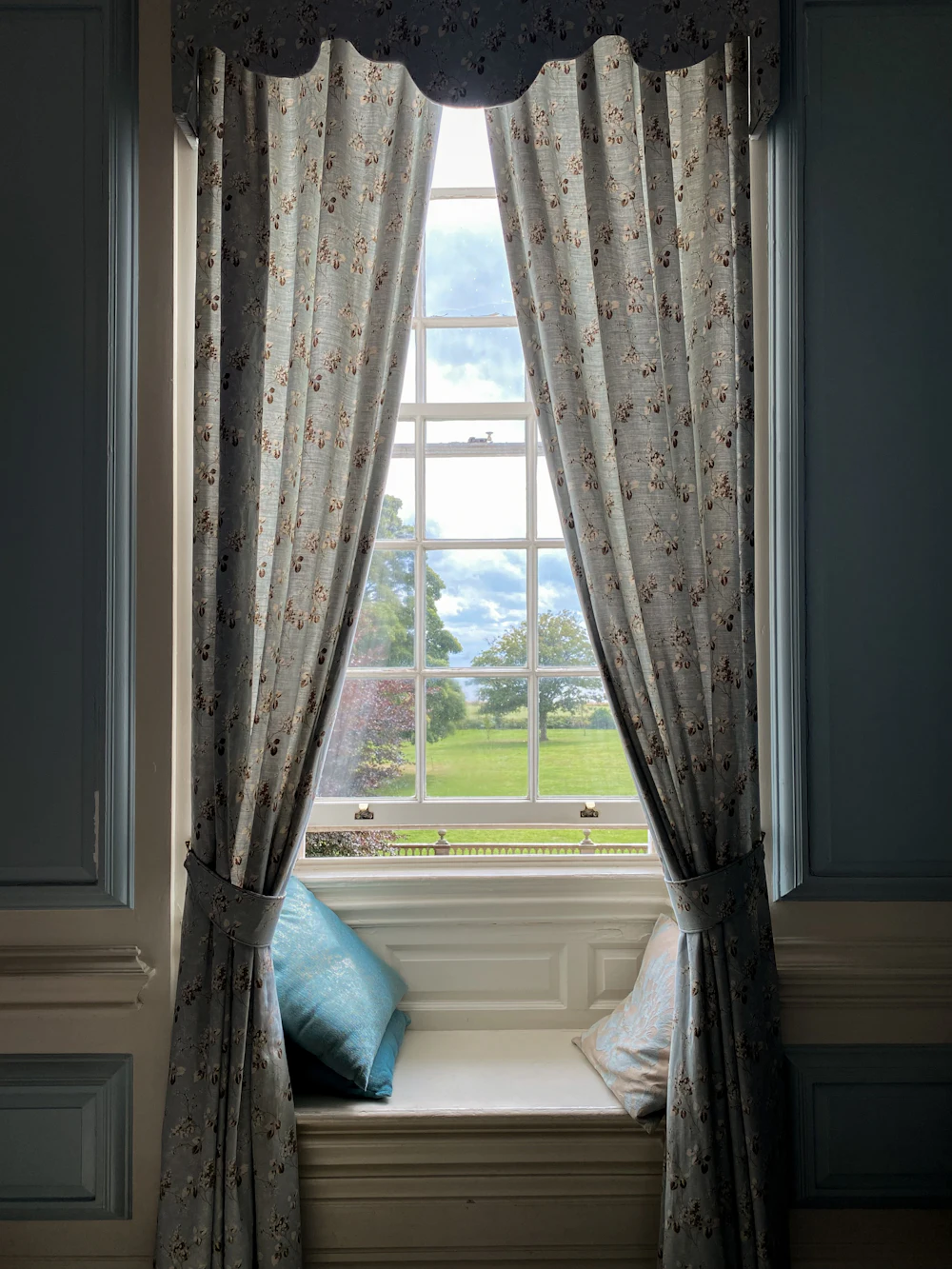 Patterned curtains framing a window