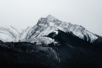 Snow-covered mountain peak under a cloudy sky