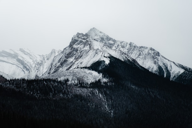 Snow-covered mountain peak under a cloudy sky