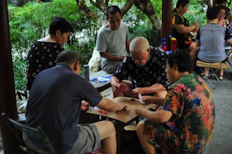 People gathered around a table playing a game.