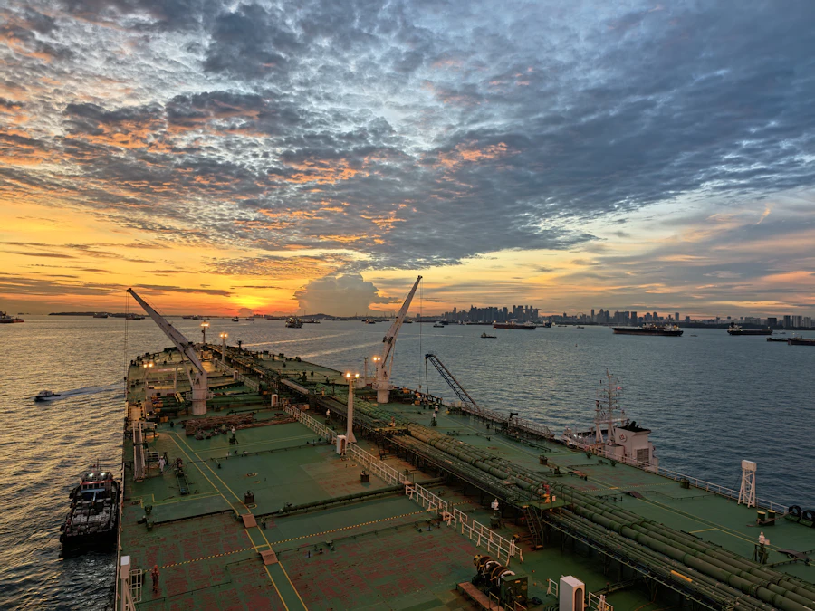 A large ship entering harbour at sunset