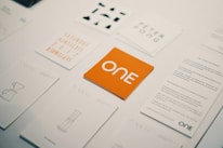 Orange card with "one" logo surrounded by other cards