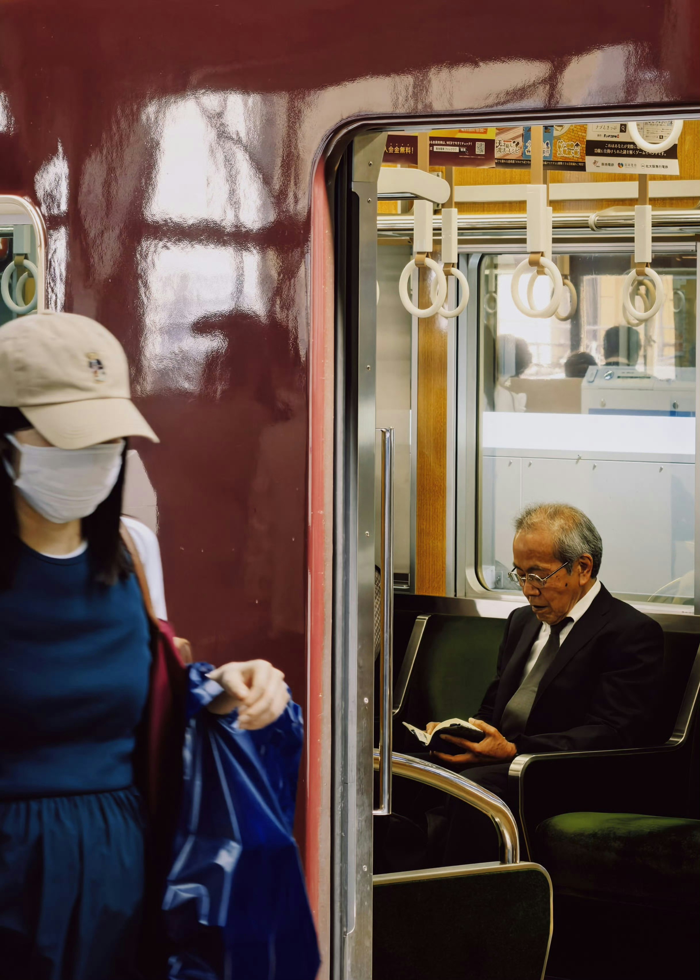 電車の中で本を読む男