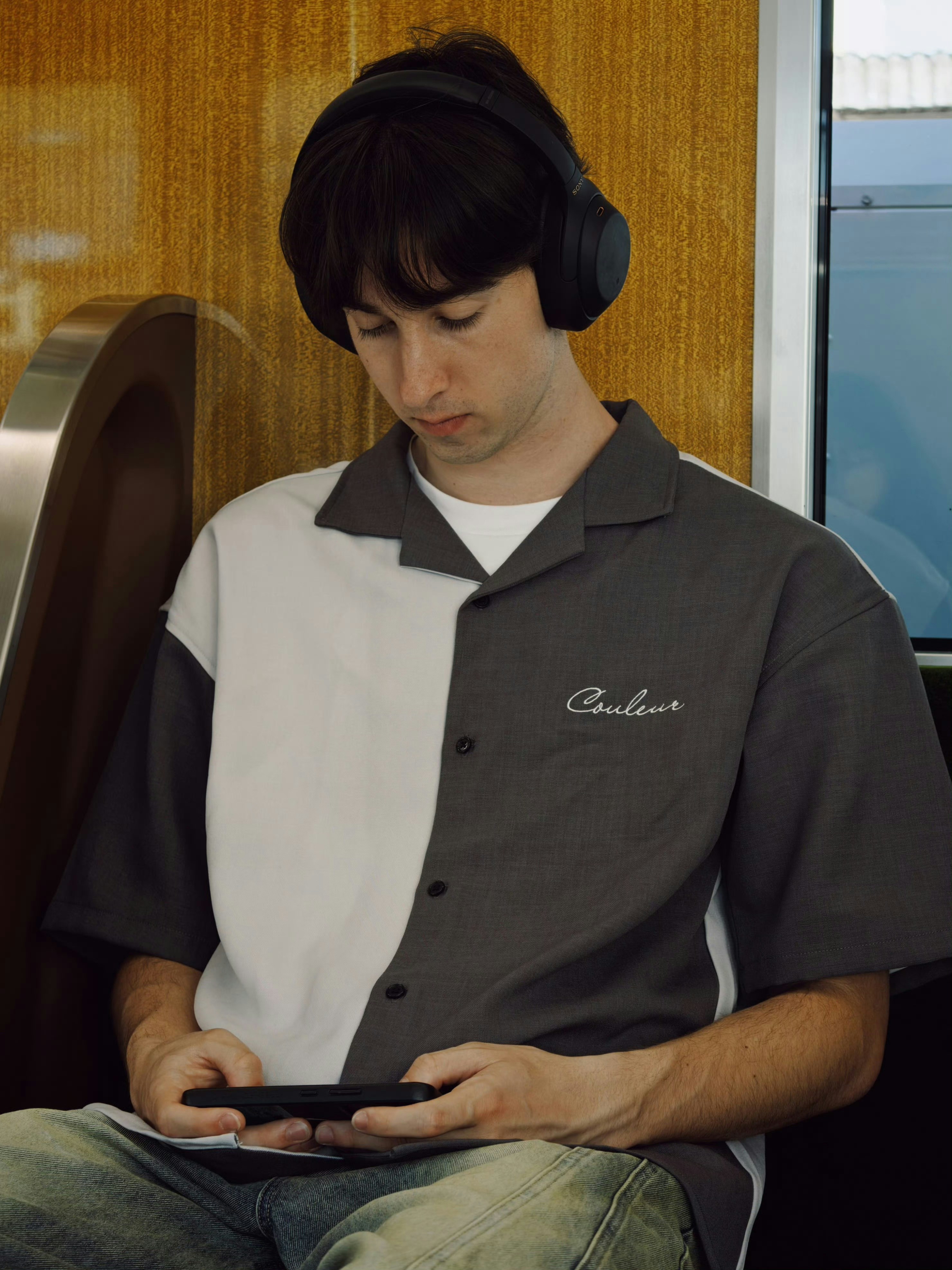 Young man wearing headphones on a train