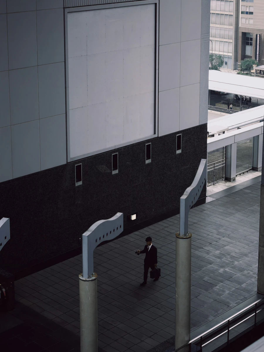 A businessman in a suit walking through a modern urban business district