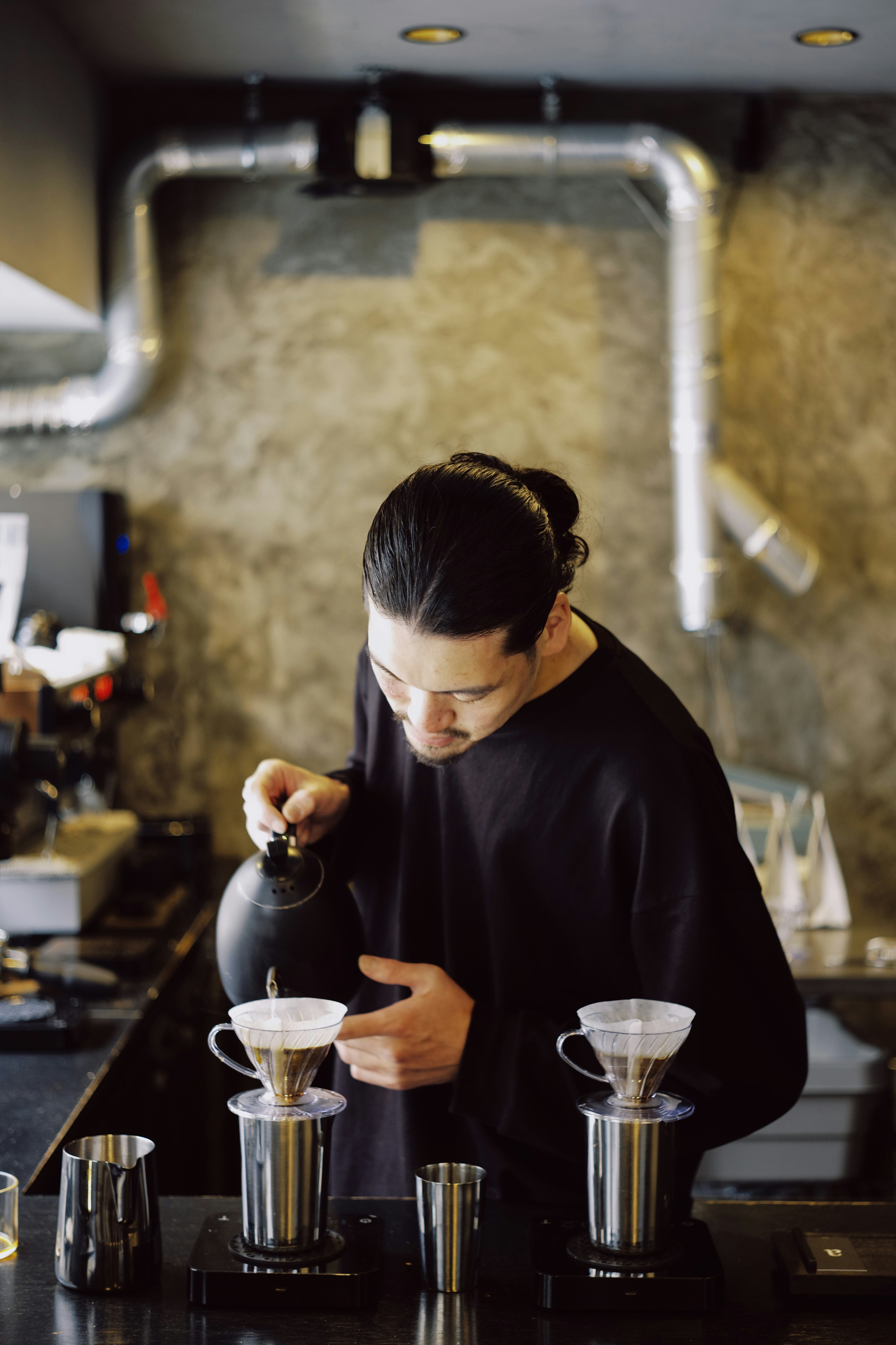 Man pouring hot water over coffee grounds