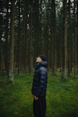 Person looking up in a dense forest