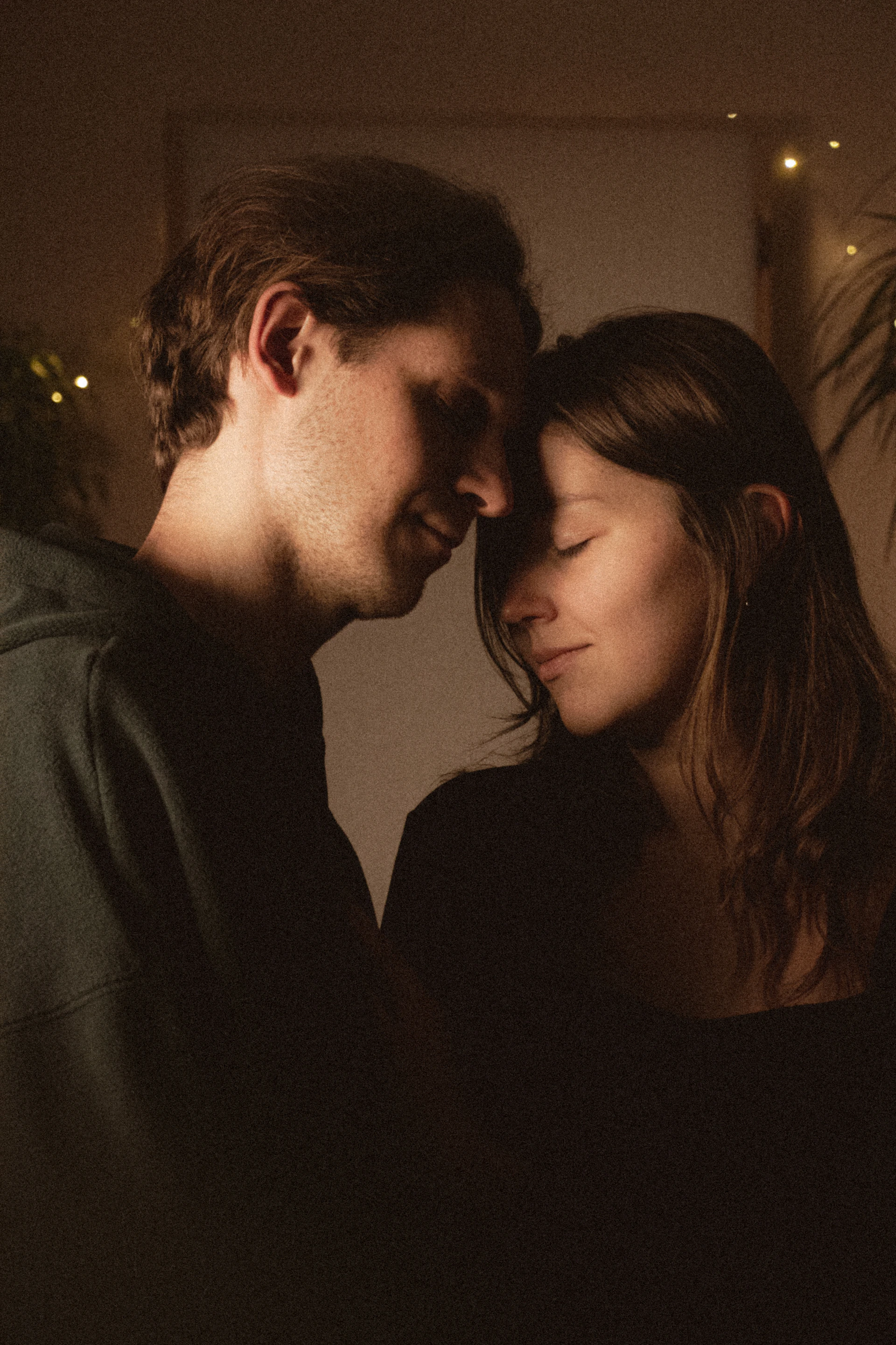 Couple embracing with eyes closed in warm light