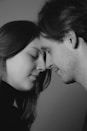 Couple with foreheads touching, eyes closed
