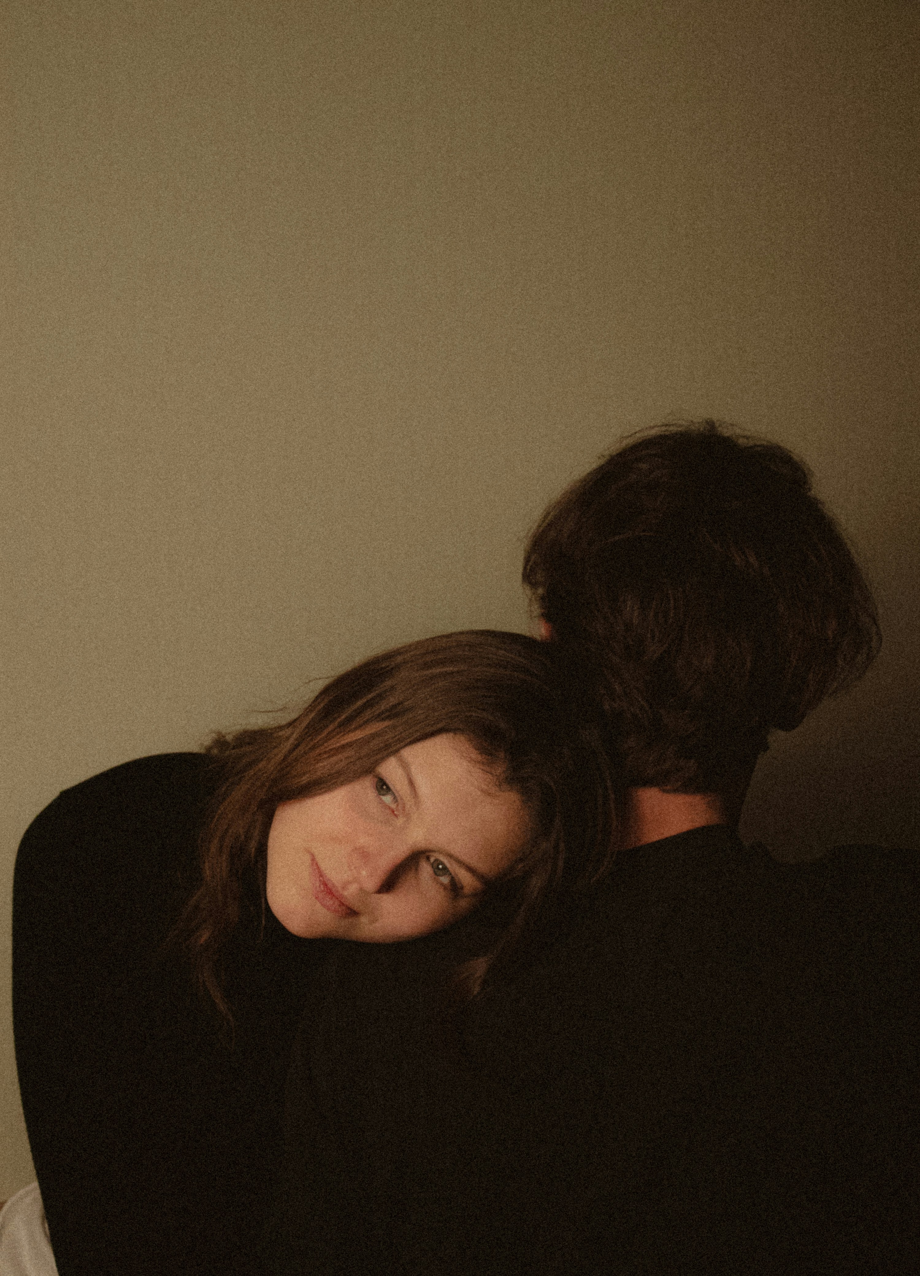 Woman resting head on man's shoulder