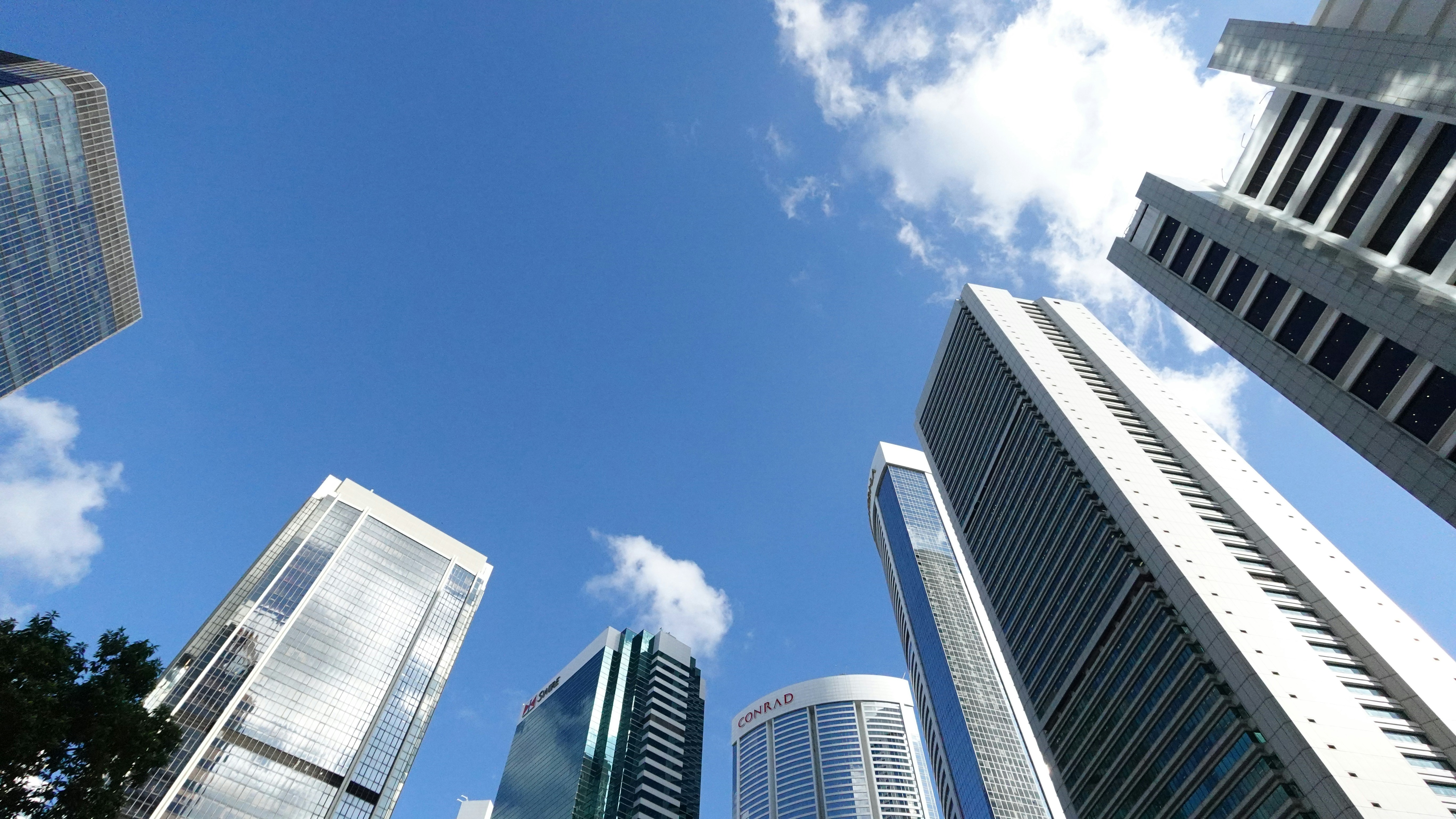 Modern skyscrapers reaching towards a clear blue sky.