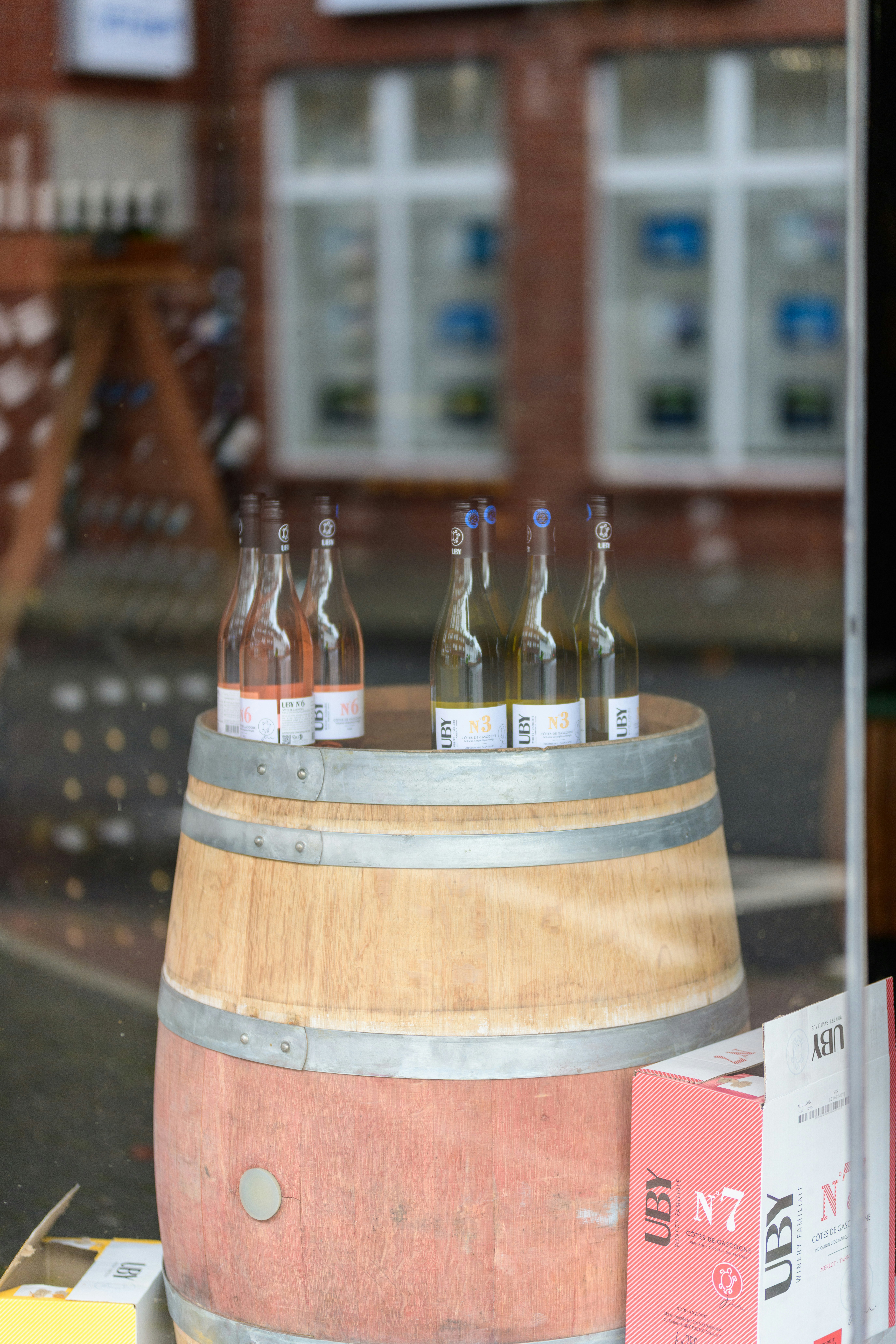 Bottles of wine displayed on a wooden barrel.