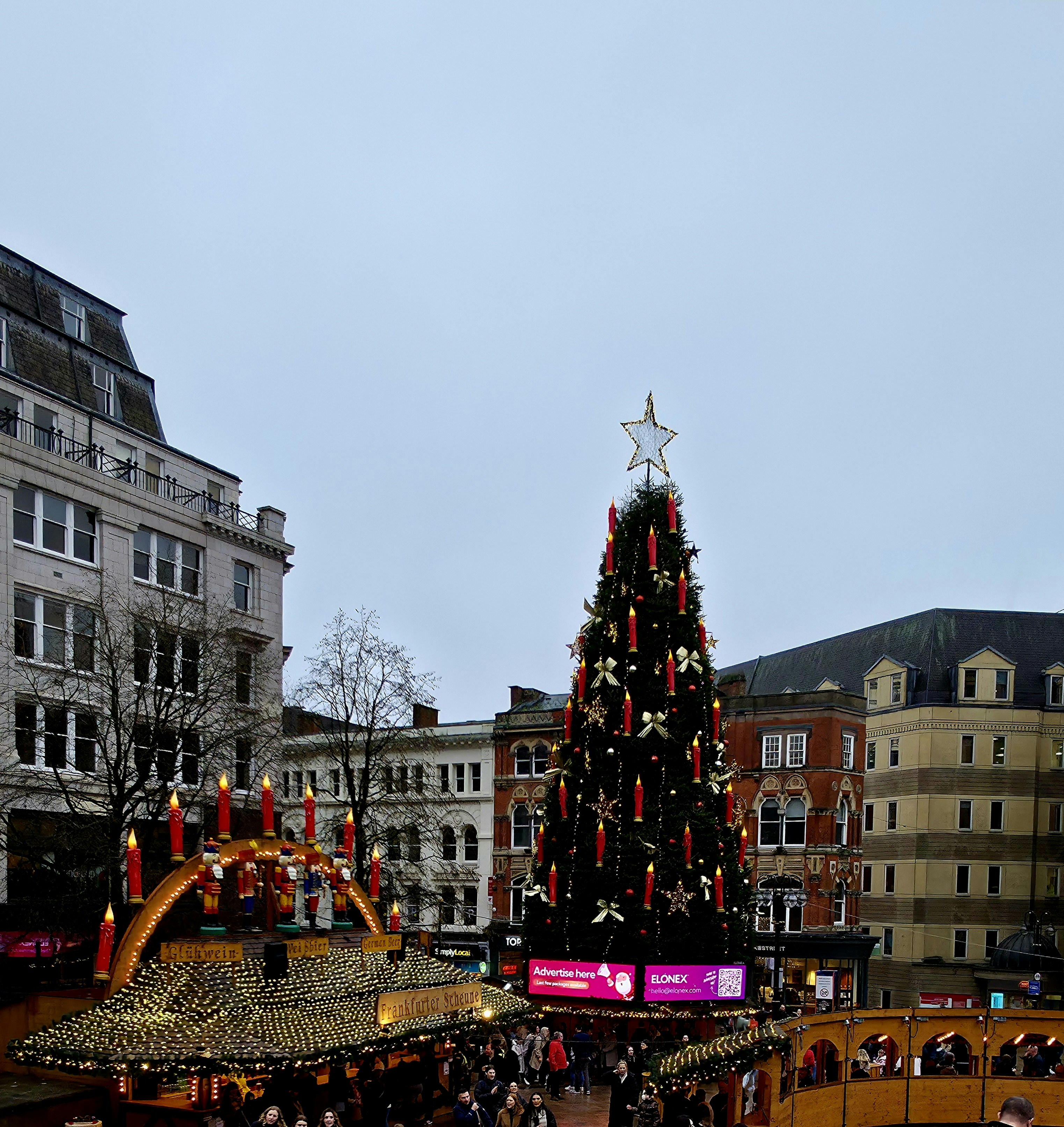 Christmas tree and market stalls in a city square