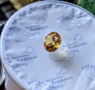 A faceted yellow gemstone on potato chip packaging.