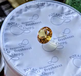 A faceted yellow gemstone on potato chip packaging.
