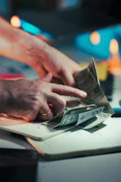 Hands counting polish banknotes on a notebook