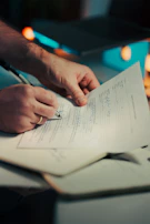 Man signing a document with a pen