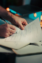 Man signing a document with a pen