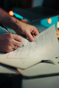 Man signing a document with a pen