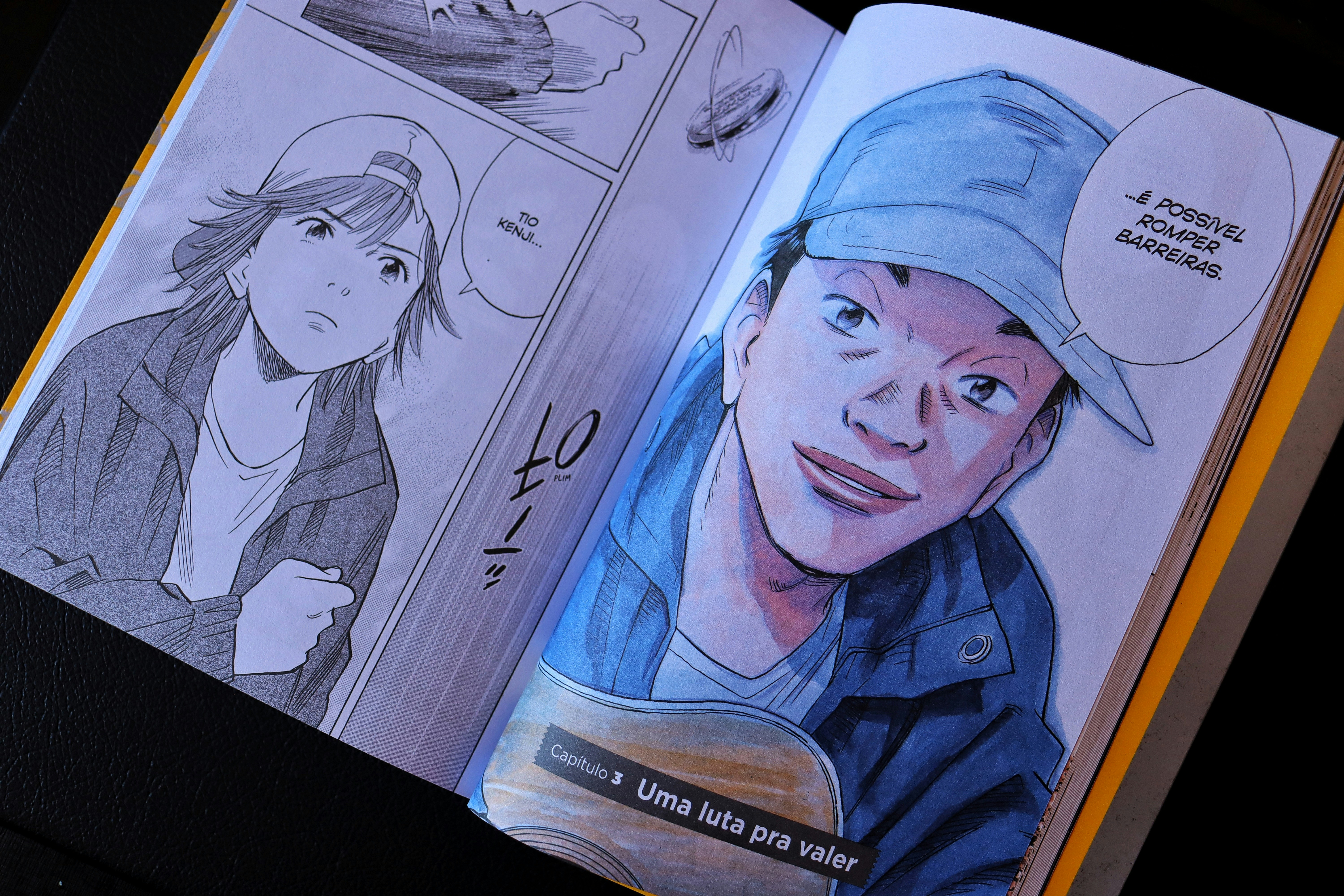 Open book displaying manga panels with character portraits.