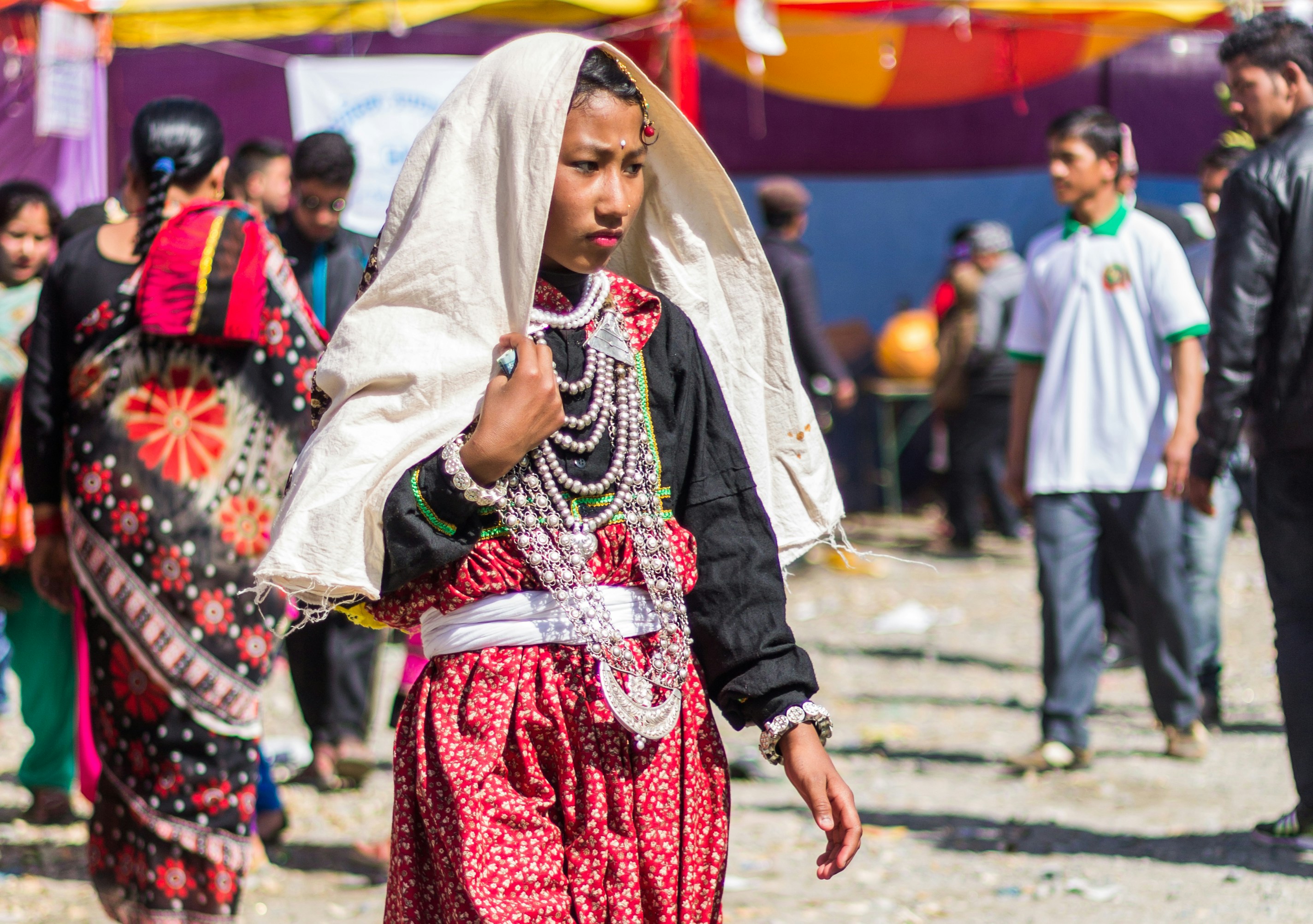 Young woman in traditional attire with beaded necklaces