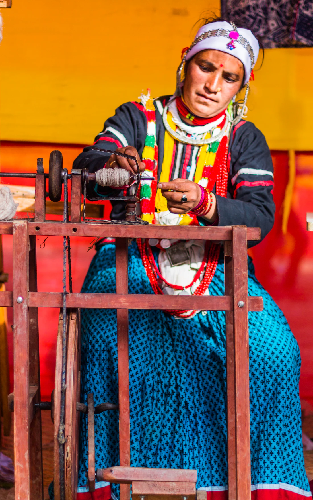 Nepali woman spinning thread traditional clothing craft