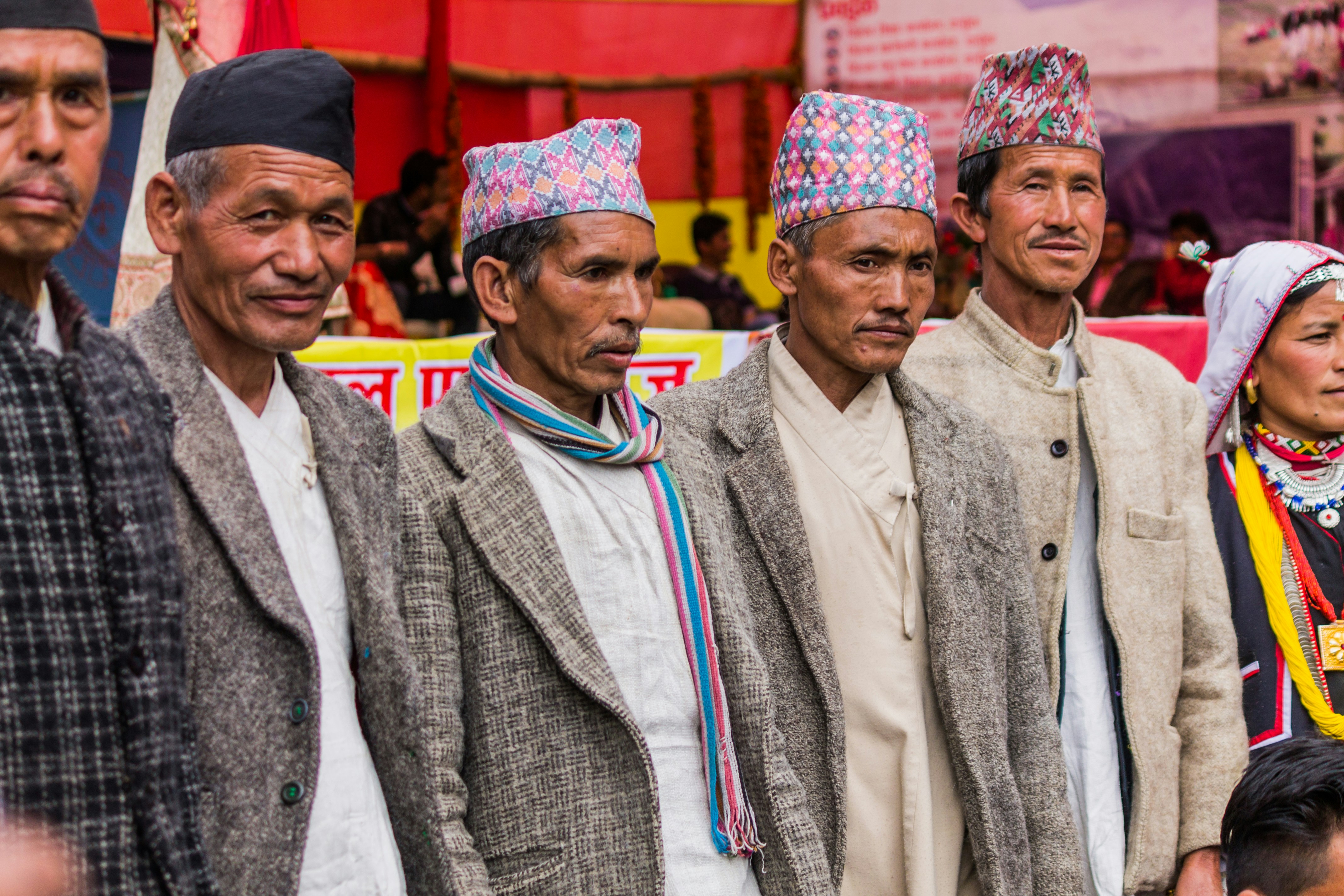 Group of men in traditional nepali hats and clothing