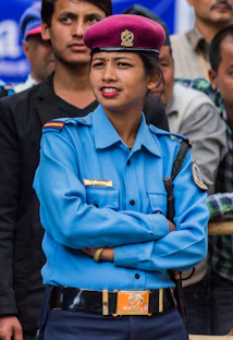 A female police officer in uniform with arms crossed