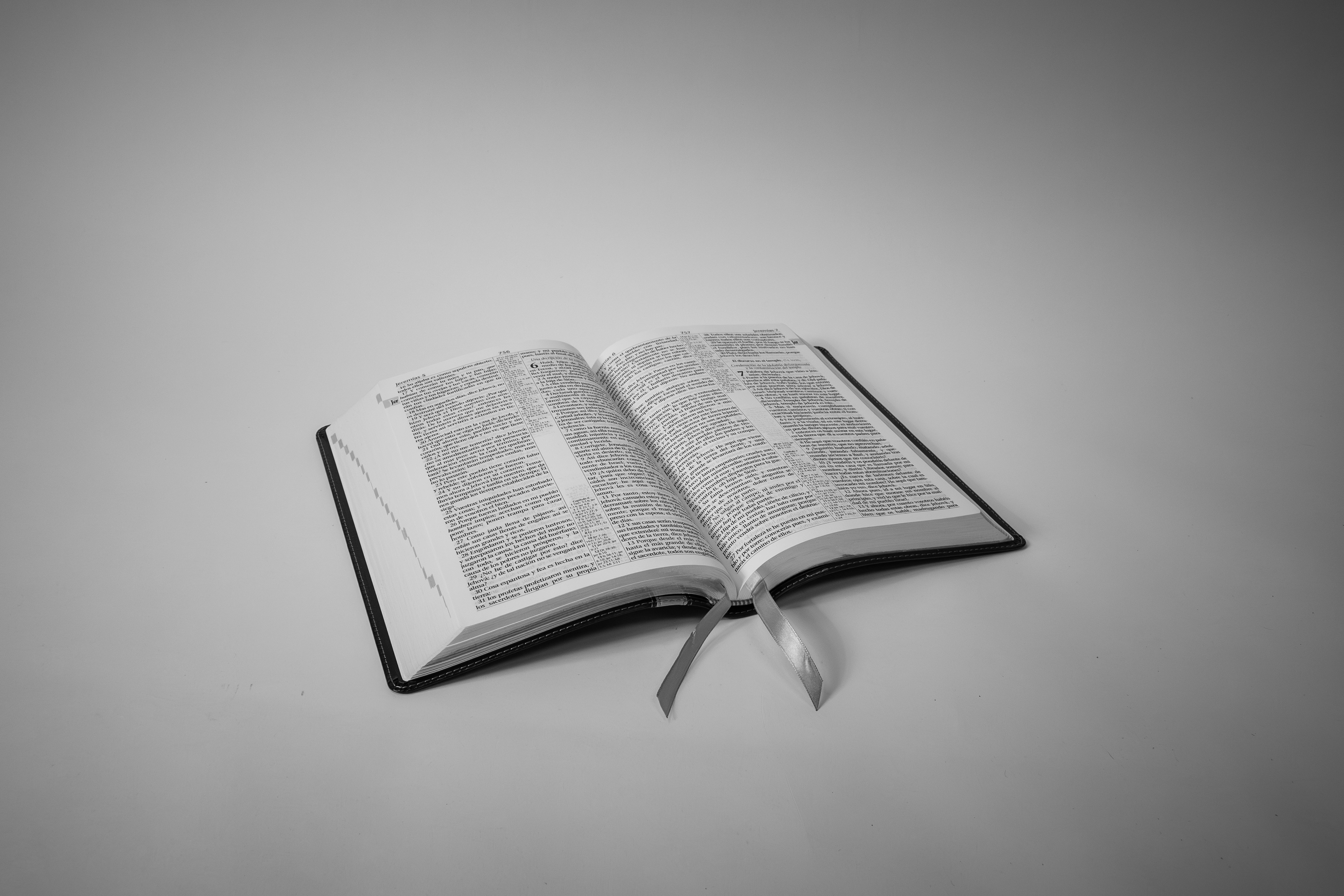 An open book with a bookmark lies flat.