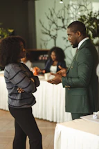 Two professionals talking in a meeting room.