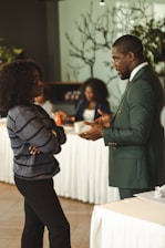 Two professionals talking in a meeting room.