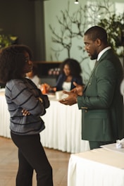Two professionals talking in a meeting room.