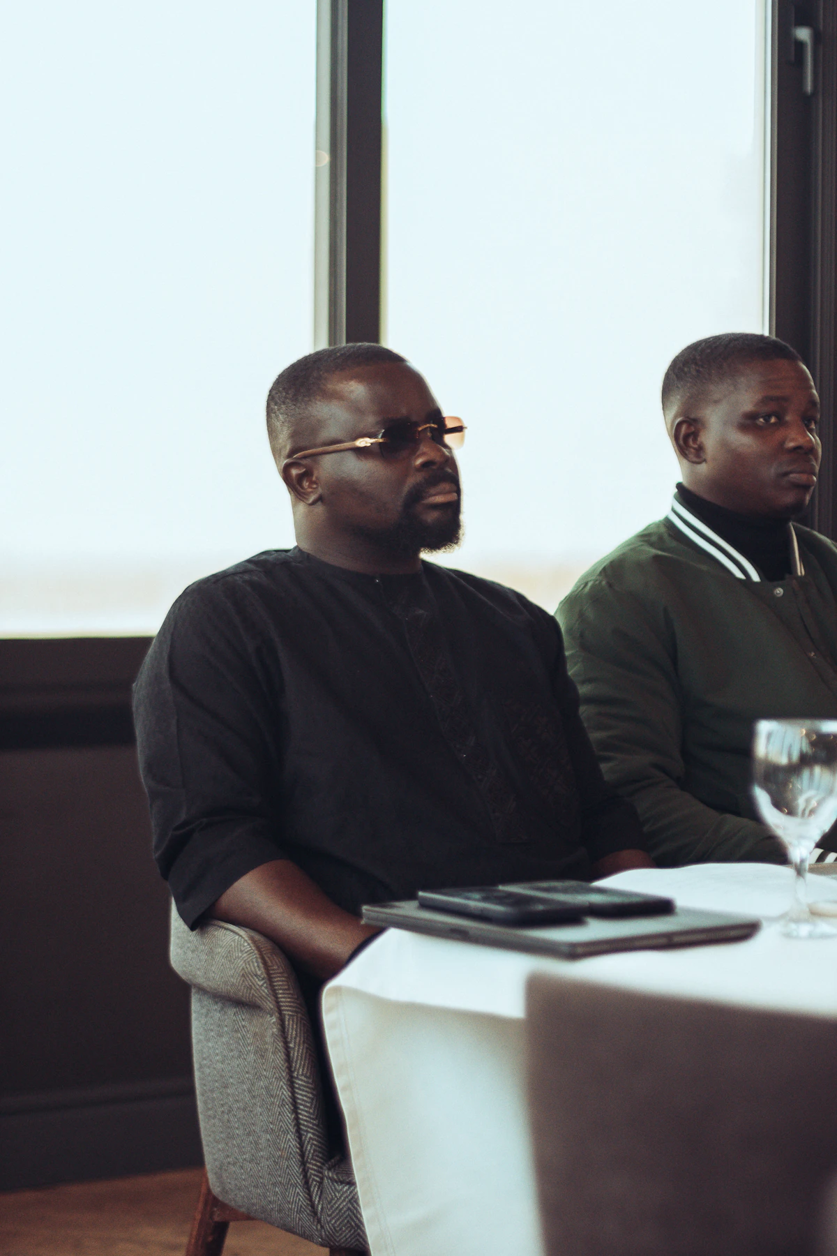 Two men sitting at a table indoors