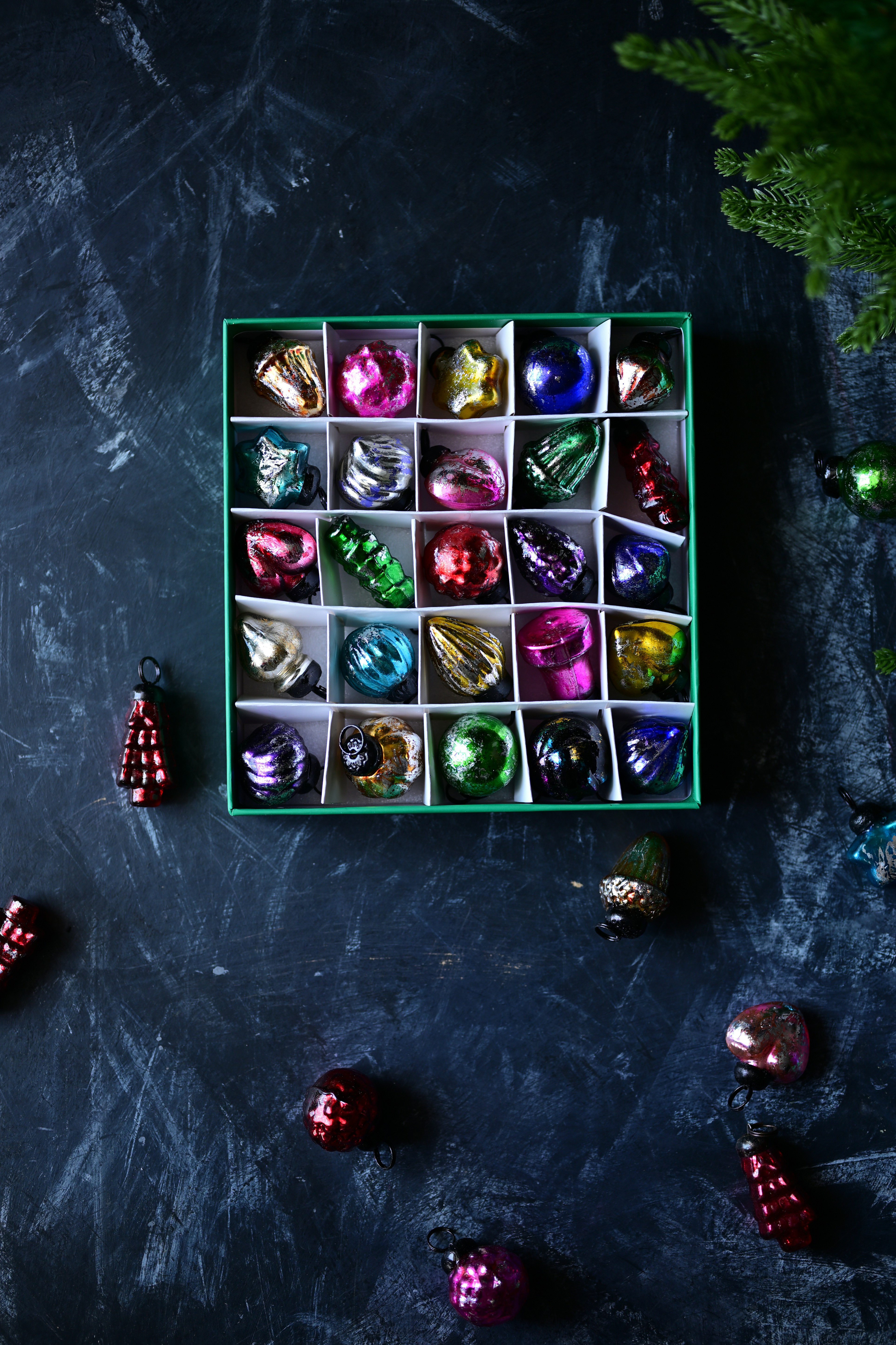 Box of colorful vintage christmas ornaments on dark background