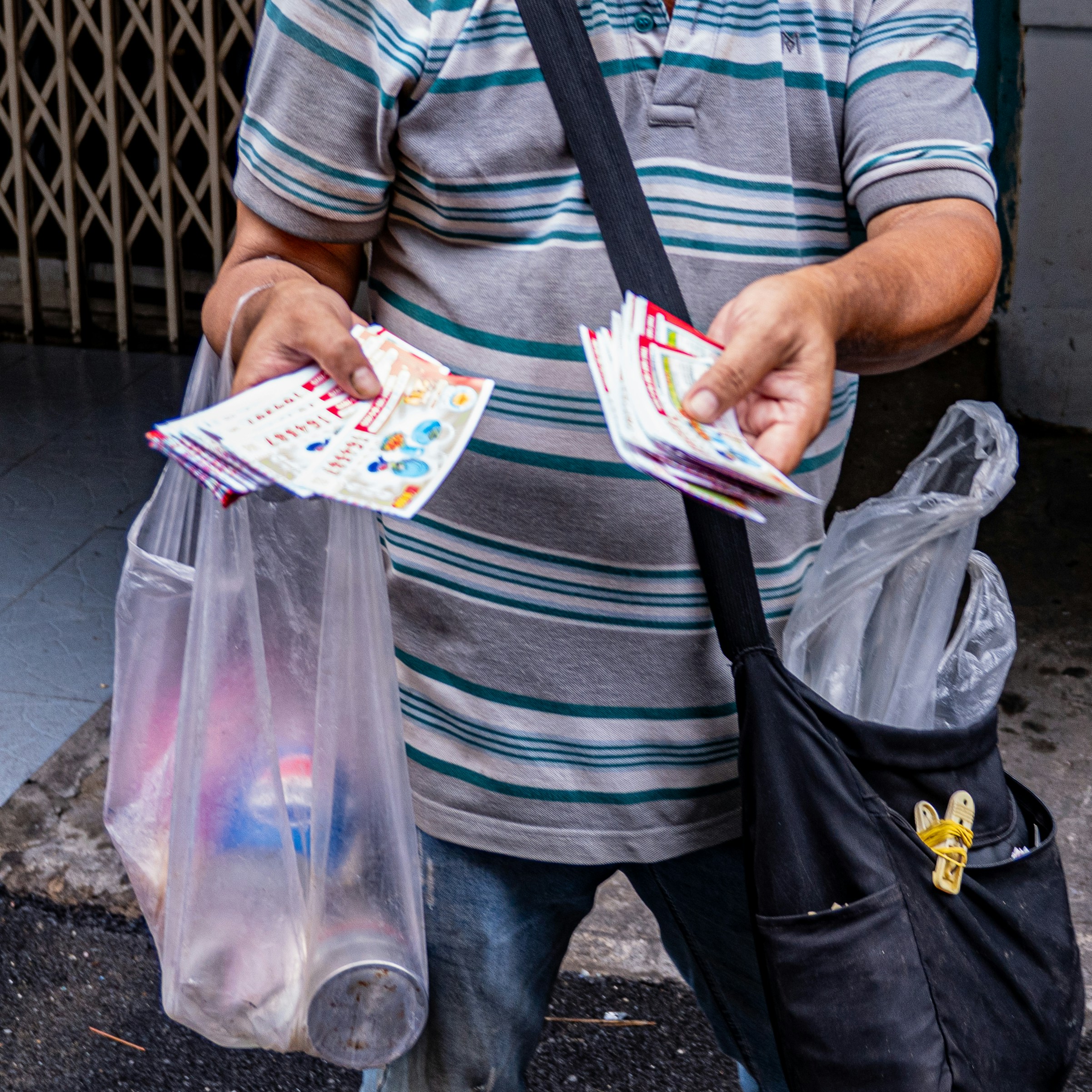 Man selling lottery tickets with bags
