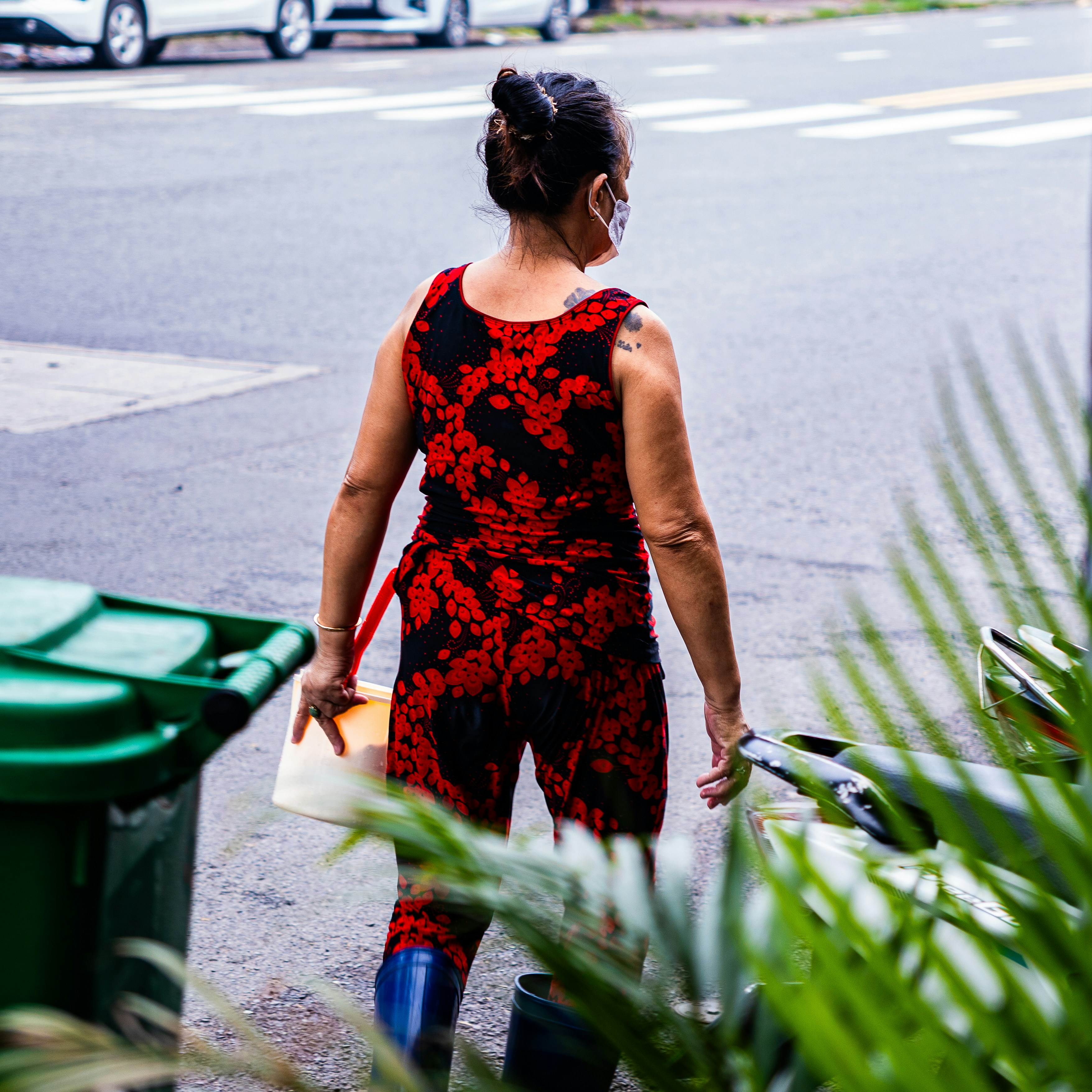 Woman in red tie-dye outfit walks outdoors