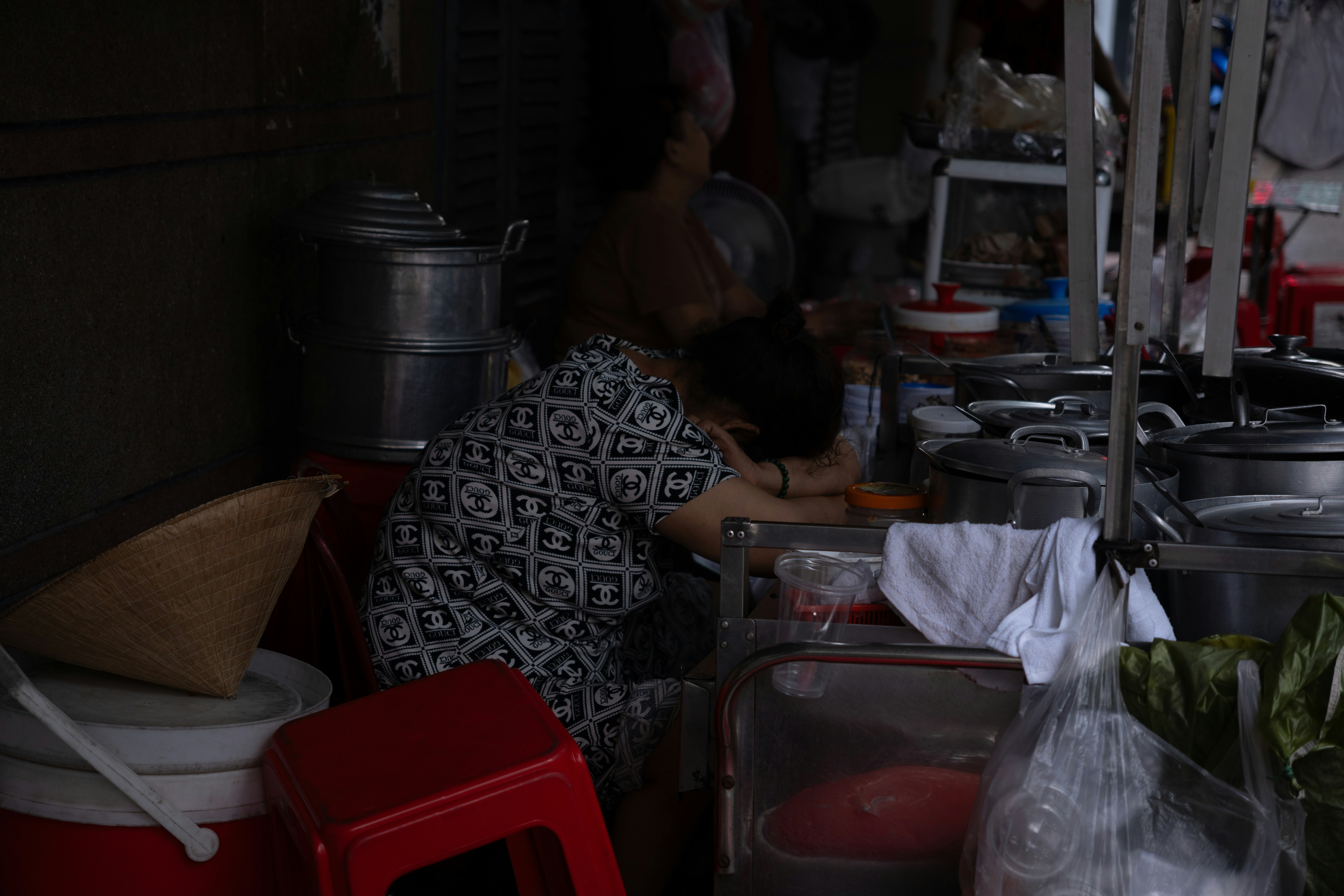 A person working in a busy food stall
