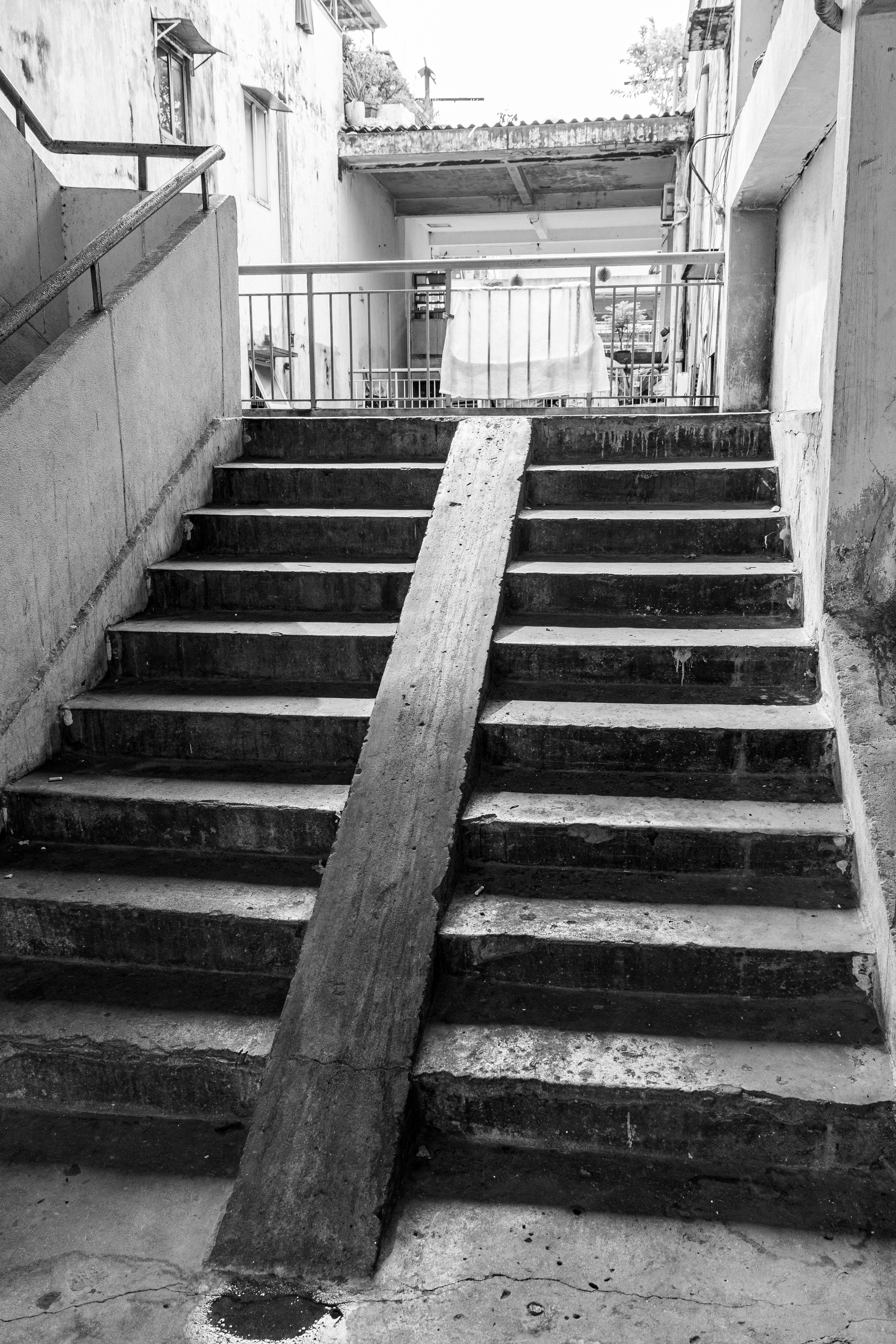 Concrete stairs with a wooden ramp in black and white.