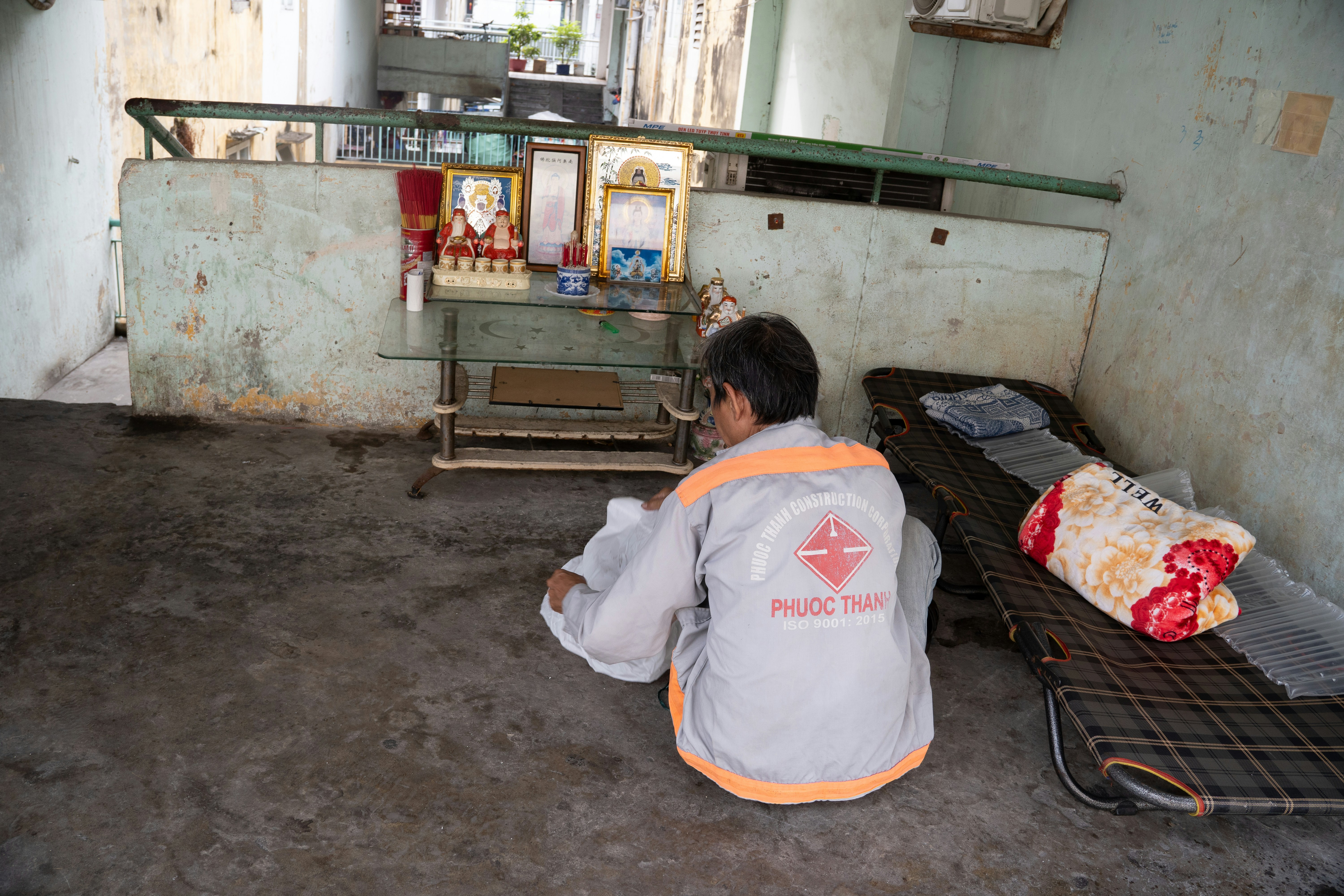 Person sitting in front of a small altar