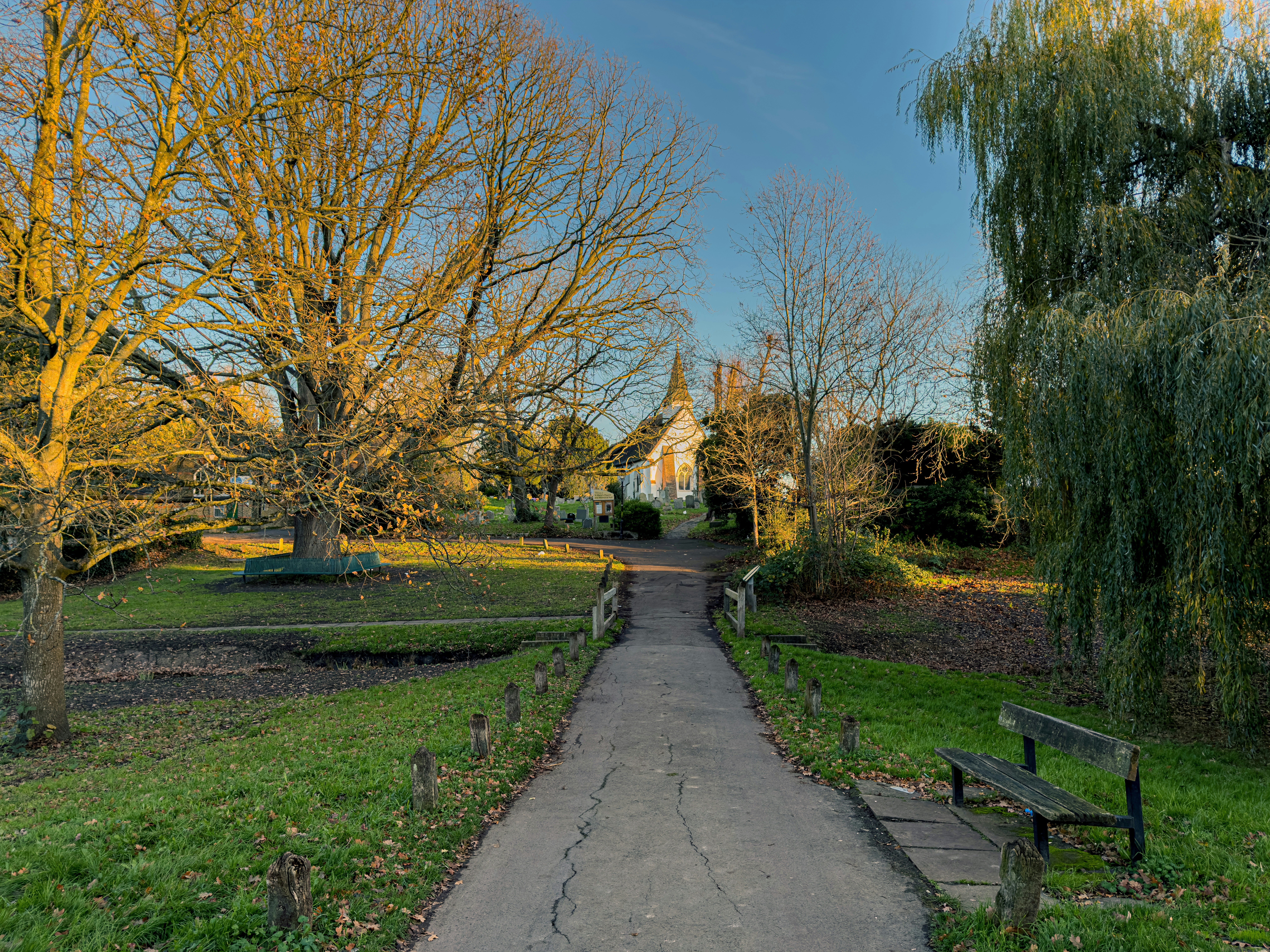 Pathway leading to a small church in a park.