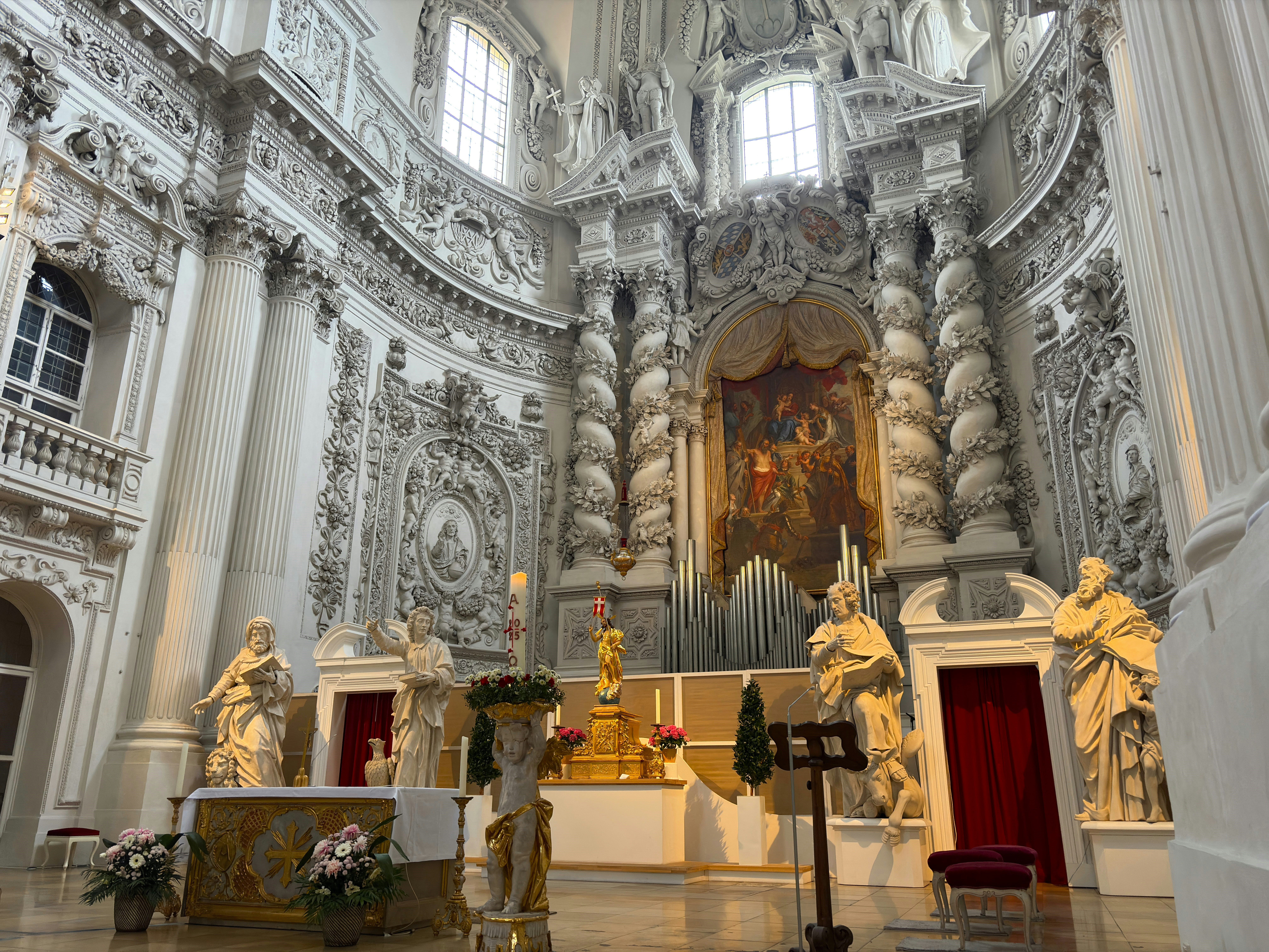 Ornate baroque church interior with statues and altar